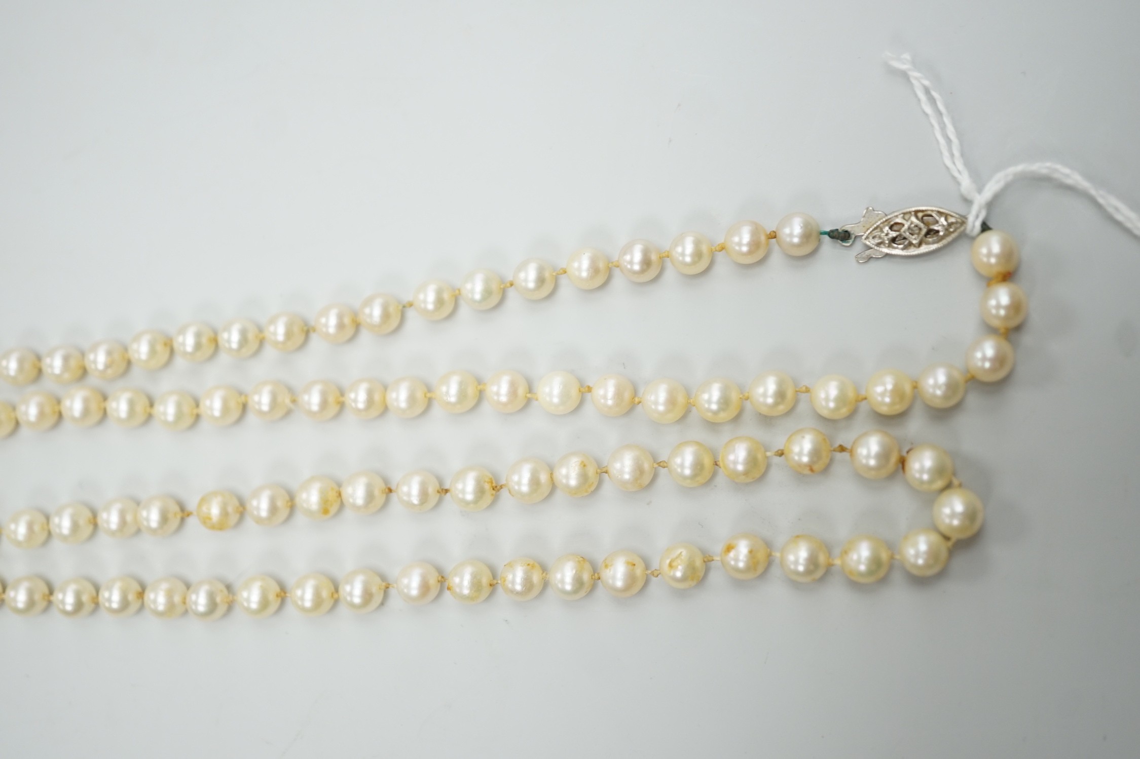A single strand cultured pearl necklace, with 9ct white gold and diamond chip set clasp, 80cm.